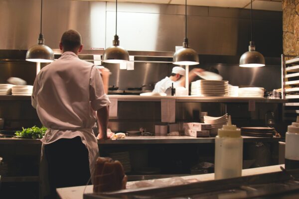 Chefs in action, walkie talkies on the server light